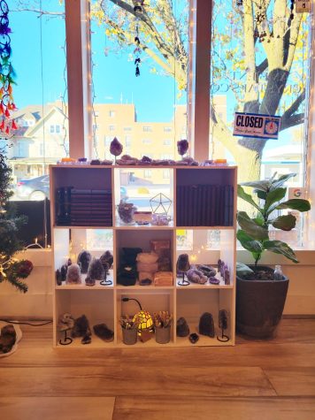 This is one of many shelves in the shop. This one prominently displays amethyst, journals, and crystal tea light candle holders, among other objects. Photo by Rowan Van Osdel