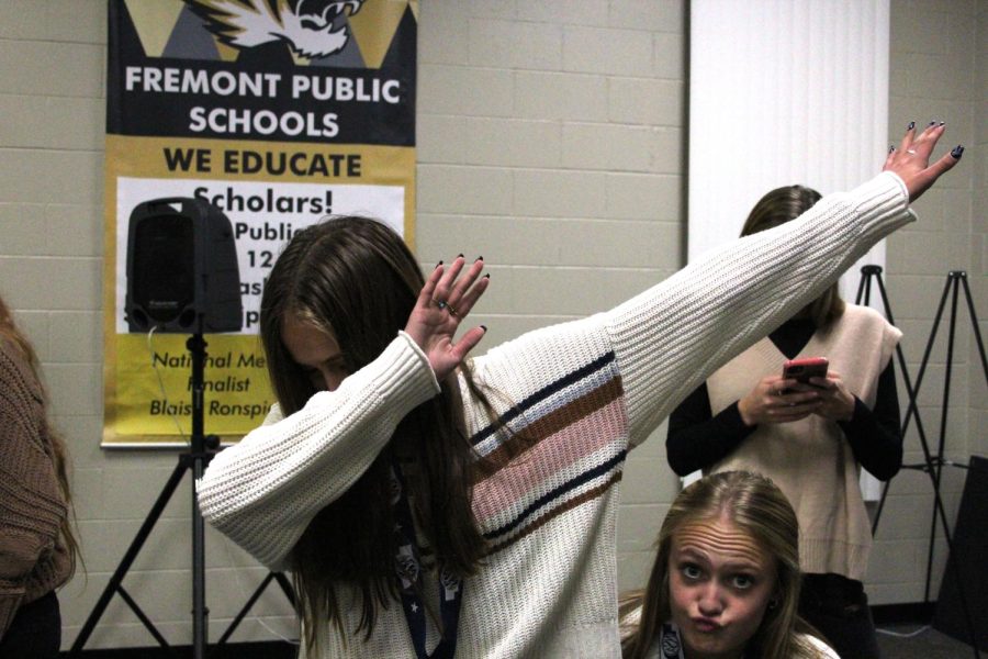 Sophomore Maris Dahl dabs for the camera while senior Elli Dahl poses in the corner. Photo by Heather Smith