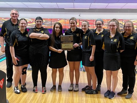 The varsity girls bowling team display their district championship award. Photo from @fhstigersports on Twitter