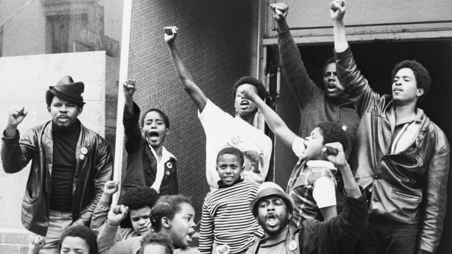 Members of the Black Panthers and children give the Black Power salute in San Francisco, California in 1969.