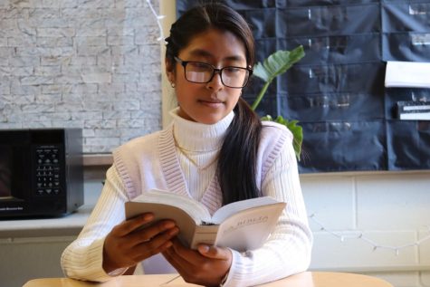 Junior Maggie Gonzalez reads her bible during free time at school. Because Gonzalez is bilingual, she studies her bible in both Spanish and English. 