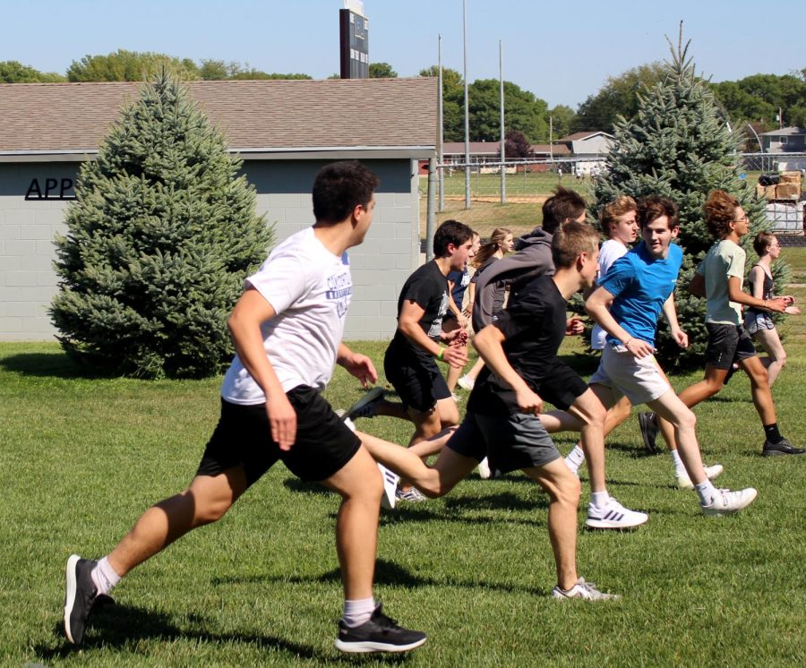 The lifting team runs outside to warm up. The gym was being used by the freshman football team, so the lifting team decided to do their pre-workouts outside. We must adapt to what is happening, coach Tucker Platt. I cant control it.