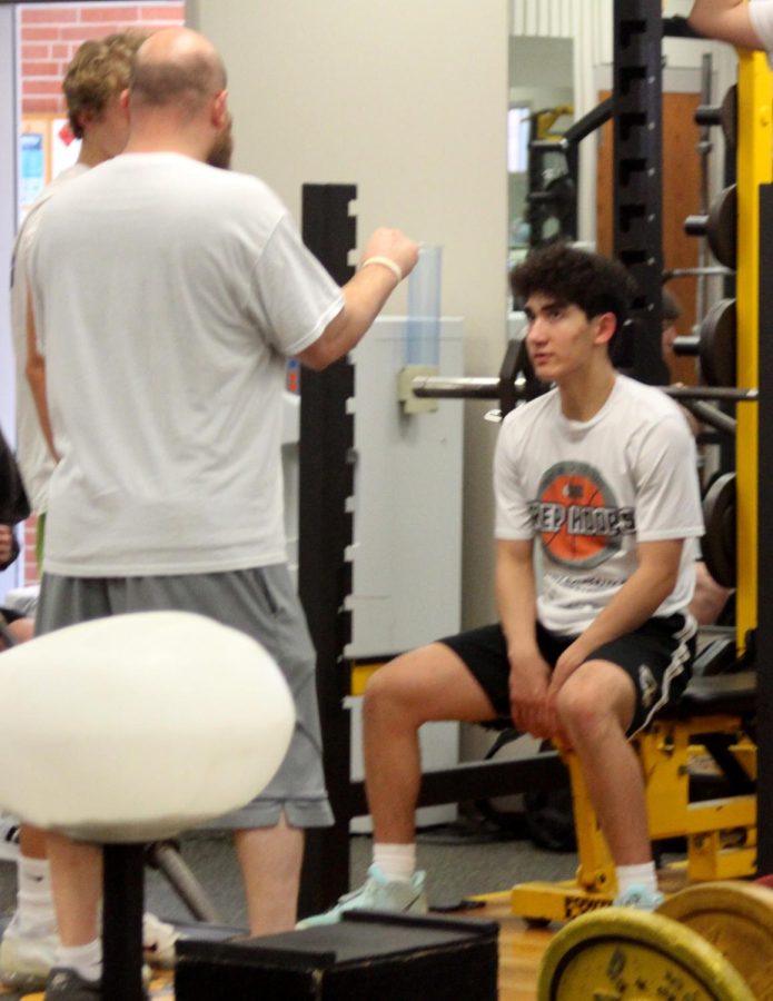 Freshman Coriahnn Gallatin receives advice and direction from coach Gallatin on his lifting form. Youre doing great, coach Gallatin said.  Just push for a few more.