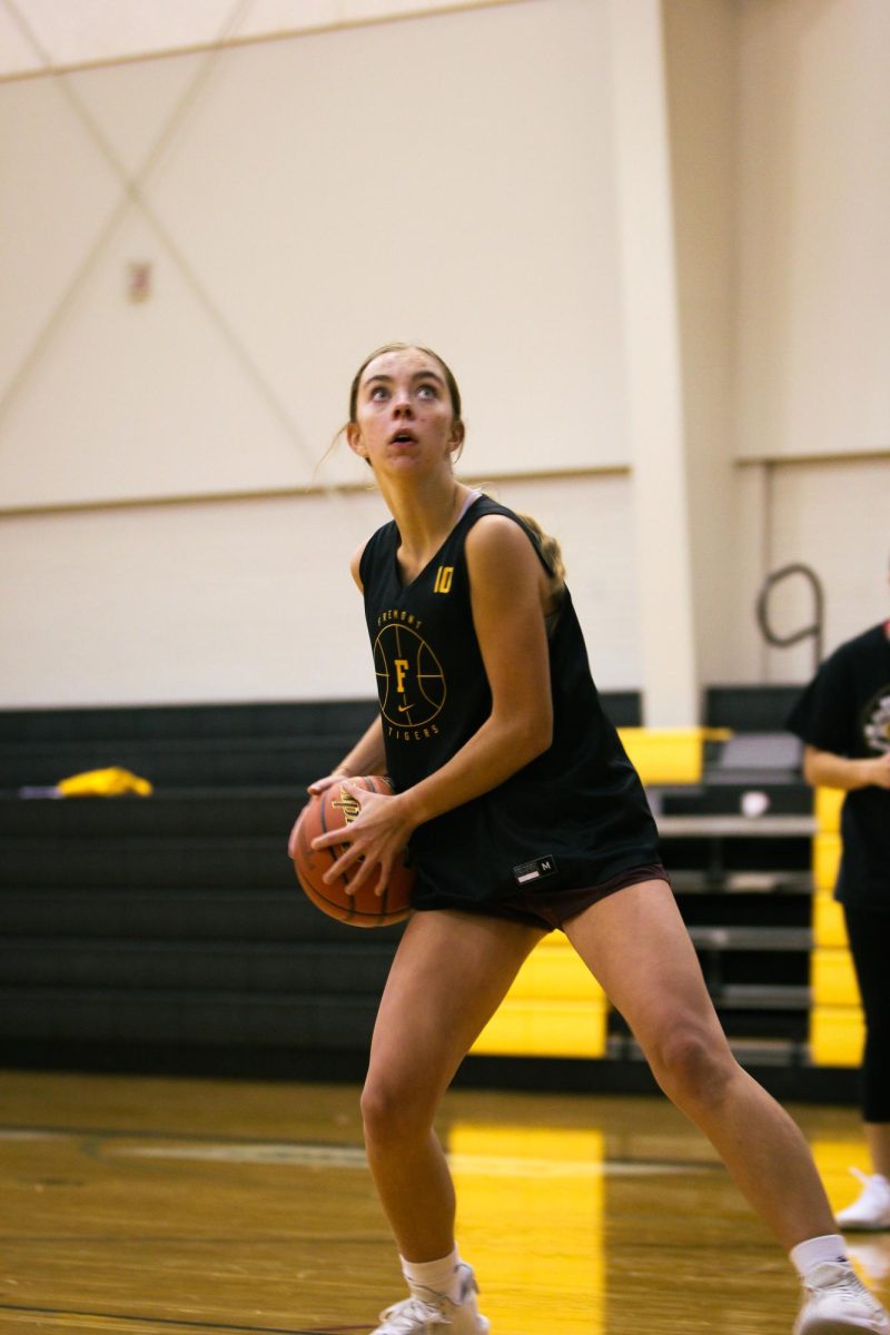Sophomore Lily Wibbels looks up to the hoop during basketball practice. This will be Wibbels first year playing on varsity. Im really just hustling during practice and trying to get in the best shape to play my best during the game,” Wibbels said. “ My teammates  have the best energy and mindsets; they encourage me; they push me to work harder in general; they are just great teammates and just people you want to be around; they also hype you up when you need it; most always leave it to Jenna McClain to scream with you after a great shot.”