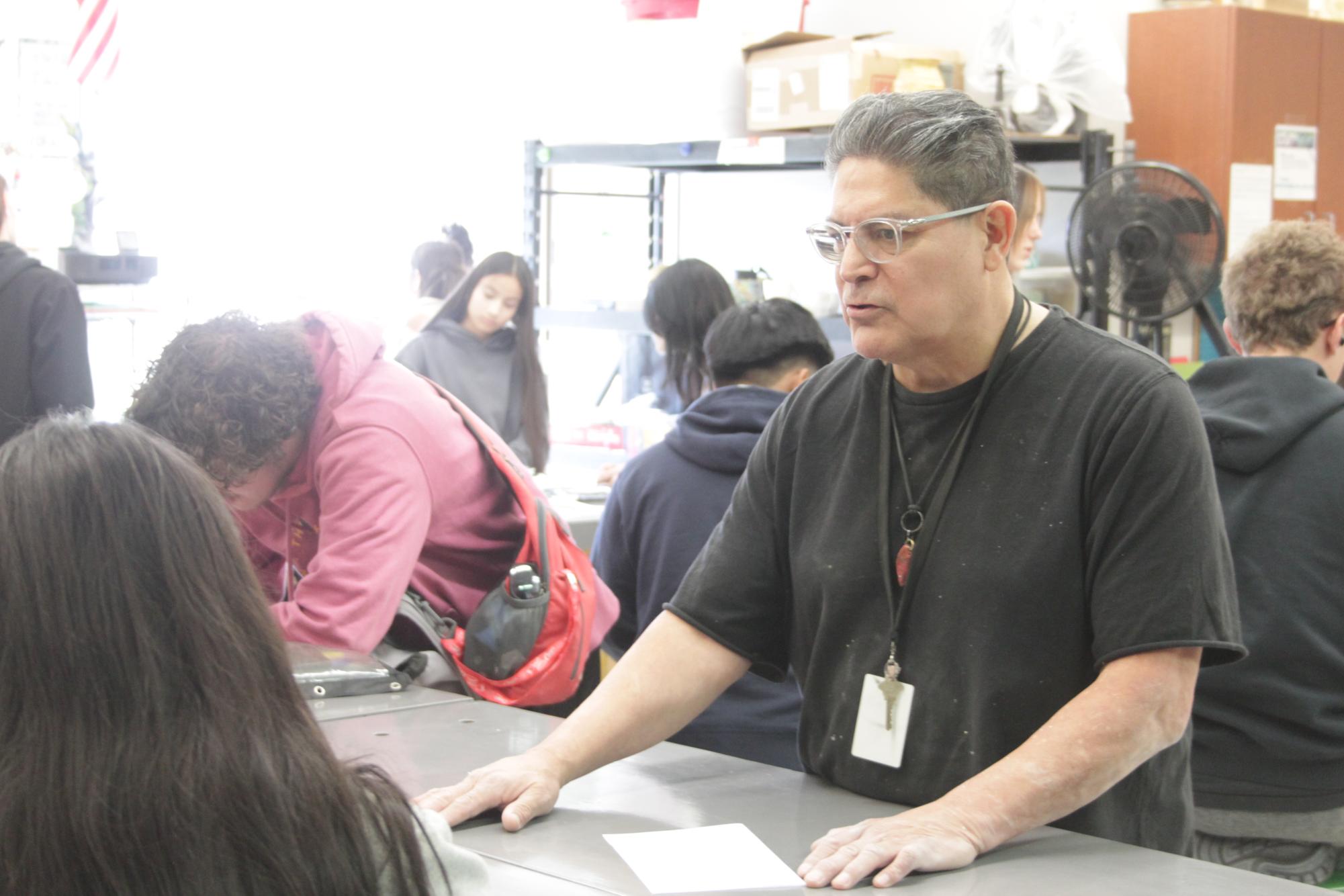 Ruben Martinez gives instructions in Spanish to students who need help. 