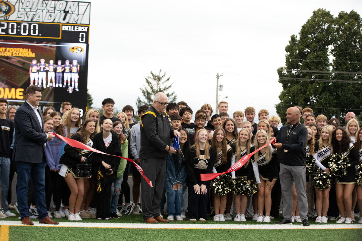 School Board member Todd Hansen cuts the ribbon at Dillon Stadium