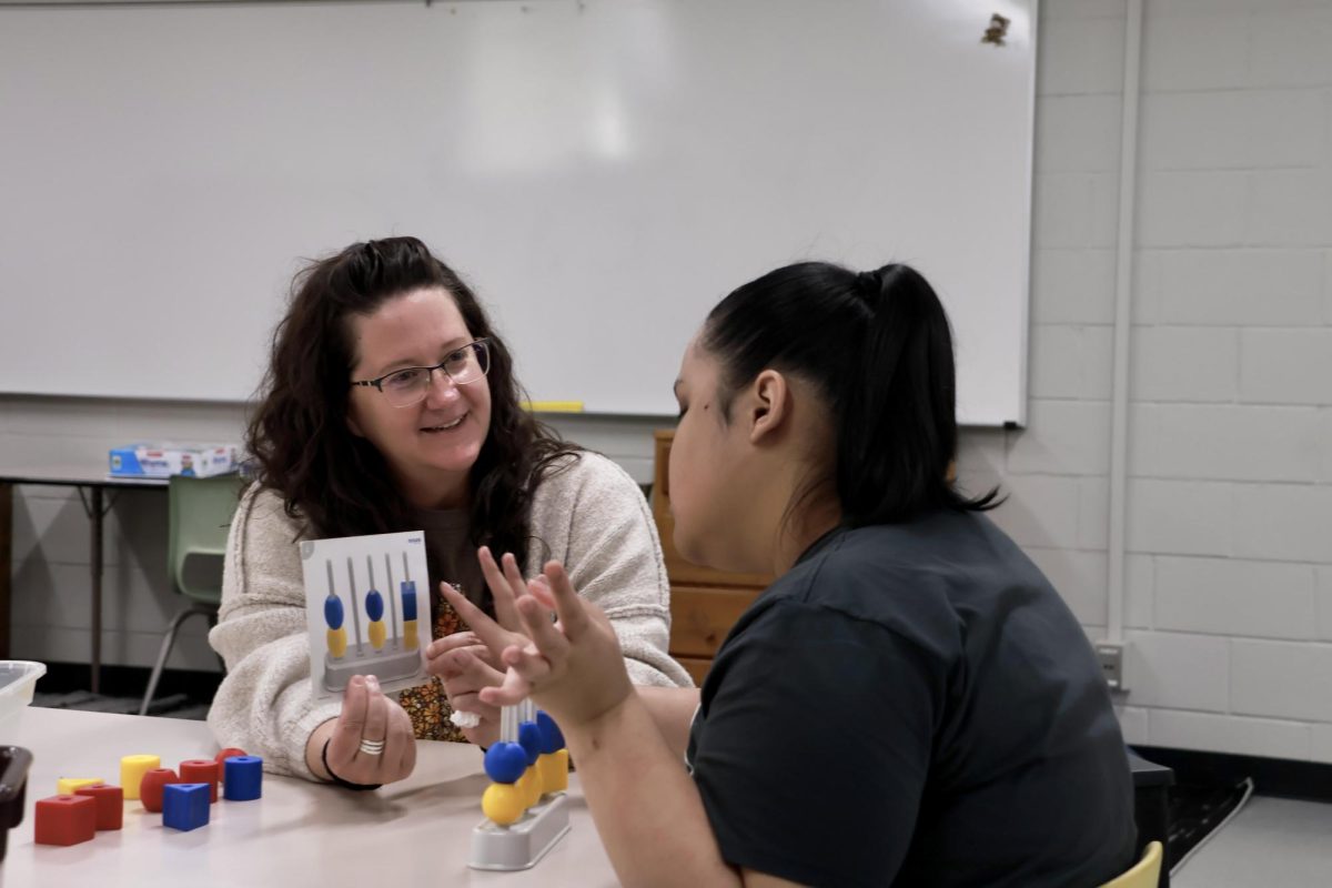 Mrs. Bigsby works with one of her students during free-time.