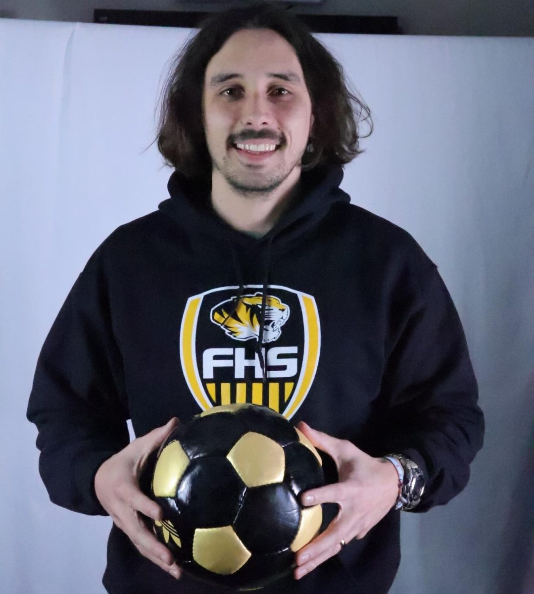 Photo of Christian Sanchez Tato holding a soccer ball. Image by Kilee Holcomb.