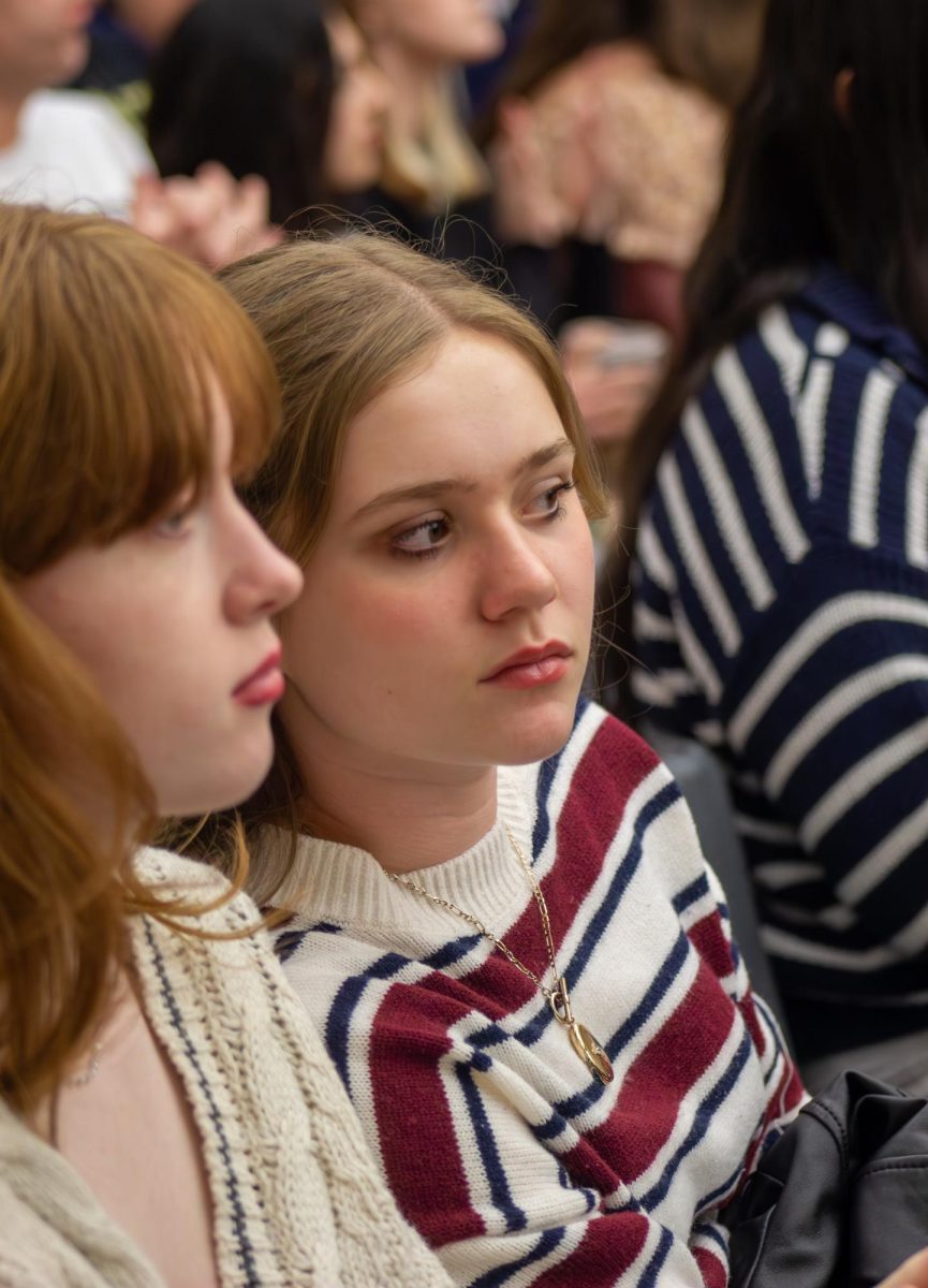 Leaning over, sophomore Rory Flanagan watches as other receive their awards. “My favorite memory was when I found out I won,” Flanagan said. “I was very excited since I’m only a sophomore but I also liked going out to eat with the group!”
