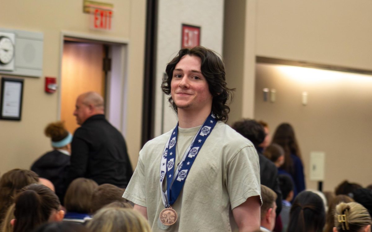 Senior Aaron Ross walks back from receiving 5th place for feature writing. “My favorite memory was seeing everyone else from Fremont walking up on stage and getting their awards,” Ross said. “It was surreal seeing everyone's efforts pay off.”