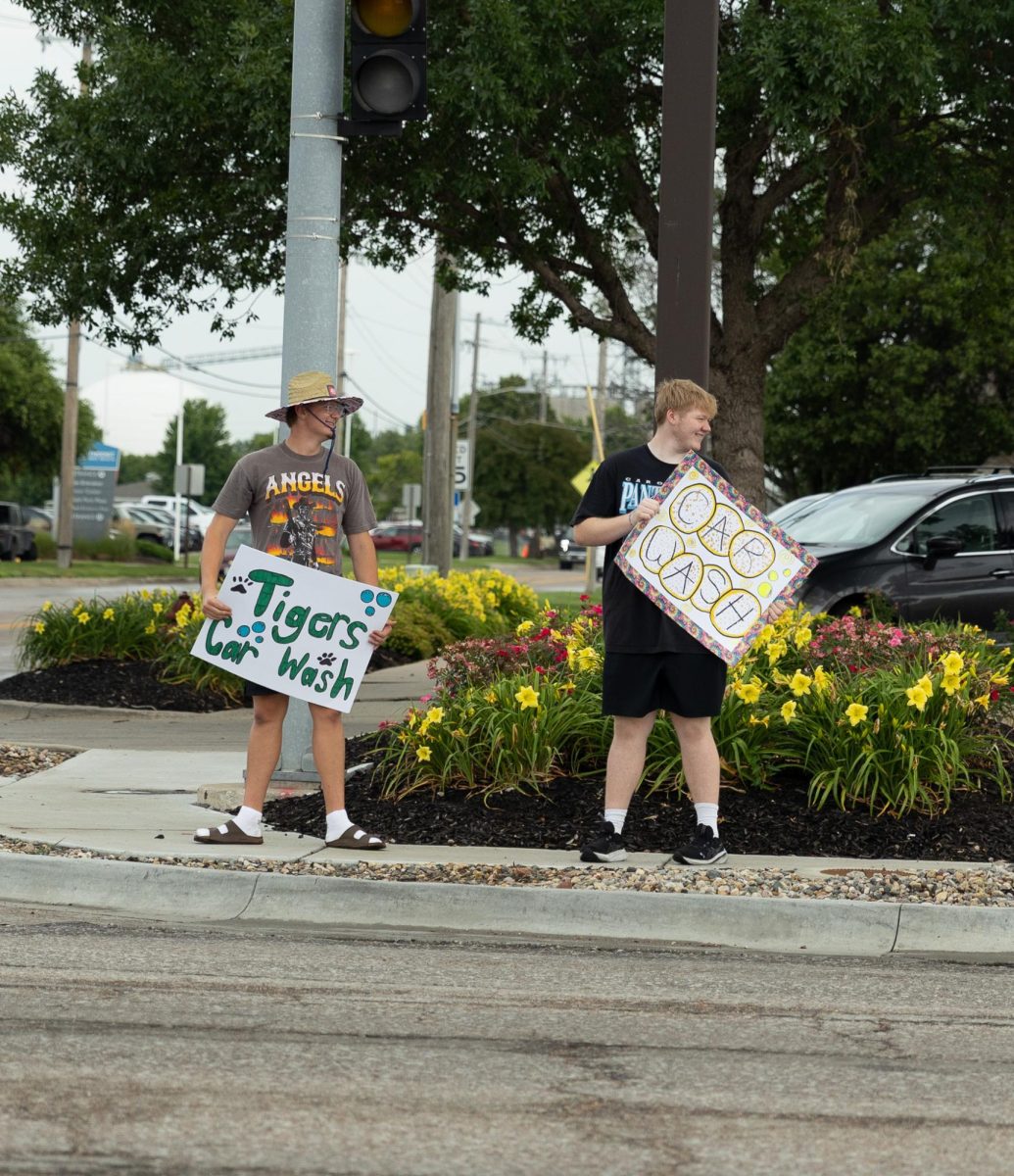 Football player Carter Hart goes to the other corner of the street to boost moral.